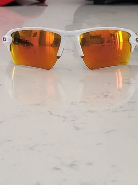 Oakley White Frame Sunglasses with Orange Mirrored Lenses